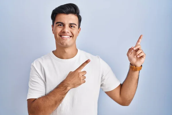 Hispanic Man Standing Blue Background Smiling Looking Camera Pointing Two — Stock Photo, Image