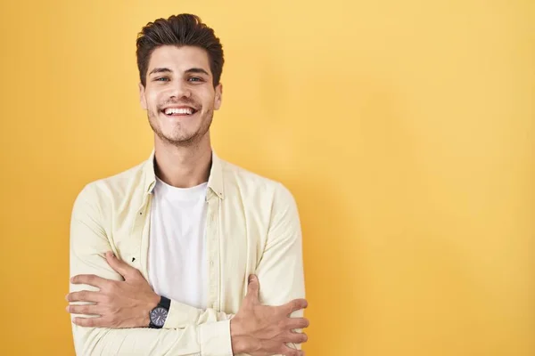 Mladý Hispánec Stojící Nad Žlutým Pozadím Šťastný Obličej Usmívající Zkříženýma — Stock fotografie