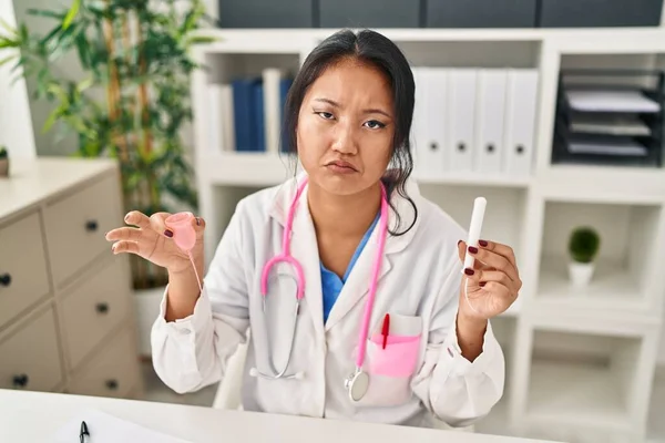 Young Asian Doctor Woman Holding Menstrual Cup Tampon Depressed Worry — Zdjęcie stockowe