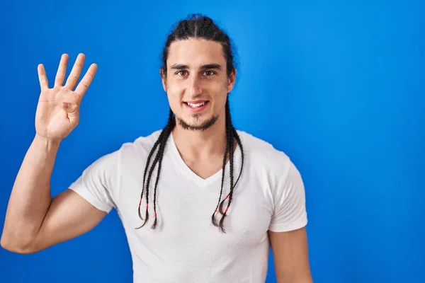 Hispanic Man Long Hair Standing Blue Background Showing Pointing Fingers — Stockfoto