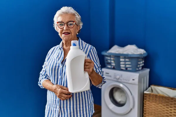 Senior Woman Grey Hair Holding Detergent Bottle Looking Positive Happy — Stock Photo, Image
