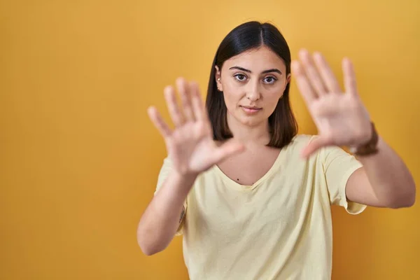 Hispanic Girl Wearing Casual Shirt Yellow Background Doing Frame Using — Zdjęcie stockowe