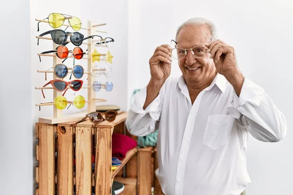 Senior man customer wearing glasses at clothing store