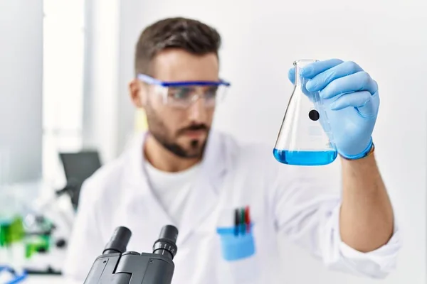 Young Hispanic Man Wearing Scientist Uniform Holding Test Tube Laboratory — Stock Photo, Image