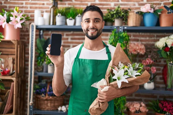 Hispanic Young Man Working Florist Shop Showing Smartphone Screen Smiling — Stock Photo, Image