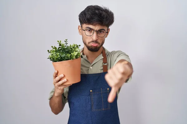 Arab Man Beard Holding Green Plant Pot Looking Unhappy Angry — Stockfoto