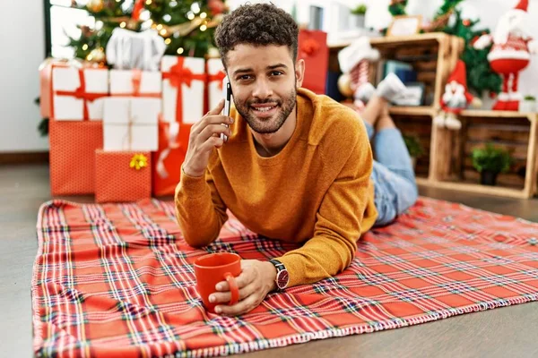 Young Arab Man Talking Smartphone Drinking Coffee Lying Floor Christmas — Stock Photo, Image