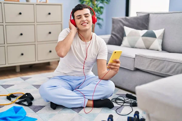 Young Non Binary Man Listening Music Sitting Floor Home — Fotografia de Stock