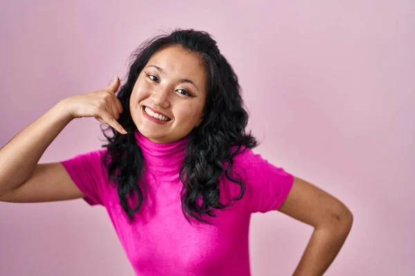 Young Asian Woman Standing Pink Background Smiling Doing Phone Gesture — Stockfoto