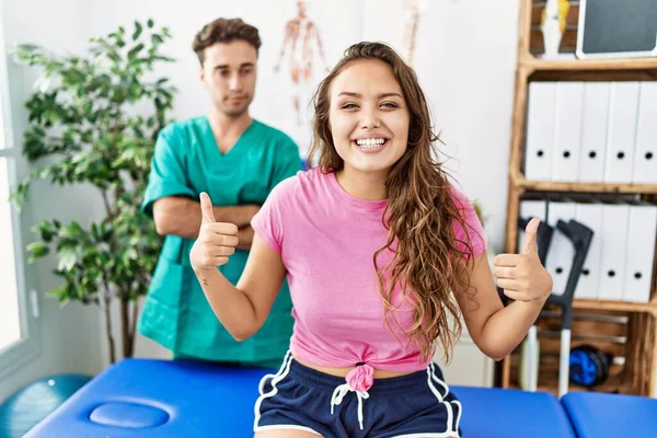 Young Hispanic Woman Physiotherapist Appointment Success Sign Doing Positive Gesture — Fotografia de Stock