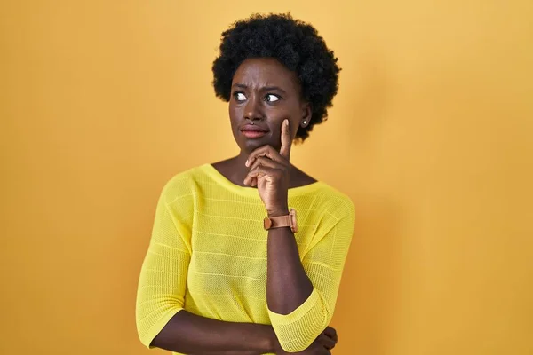 African Young Woman Standing Yellow Studio Thinking Worried Question Concerned — Foto de Stock