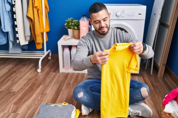 Young Latin Man Smiling Confident Folding Clothes Laundry Room — Stockfoto
