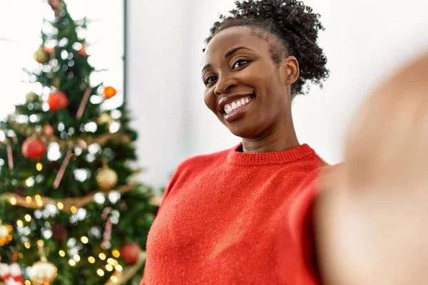 アフリカ系アメリカ人の女性は自宅でクリスマスツリーに立ってカメラによって自撮り — ストック写真