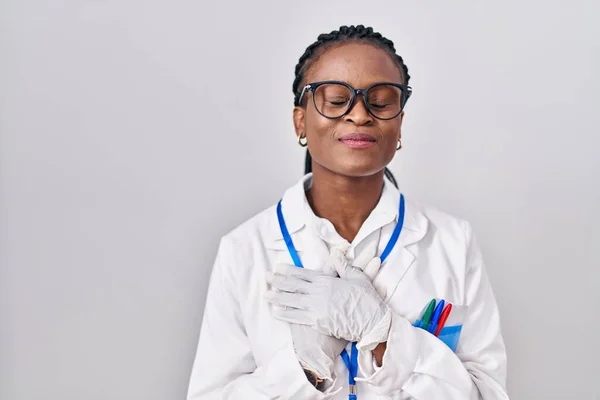 African Woman Braids Wearing Scientist Uniform Smiling Hands Chest Eyes — ストック写真
