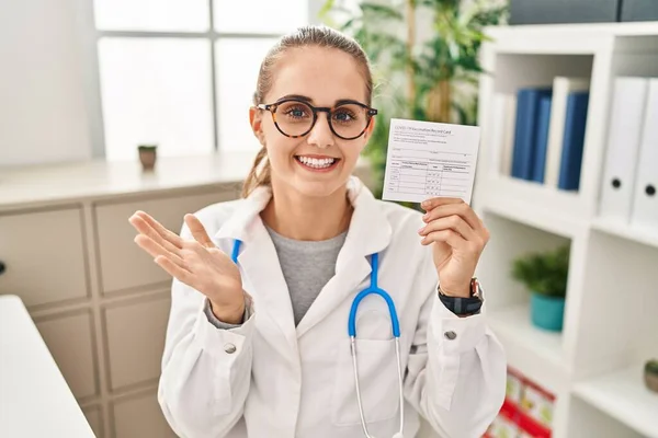 Young Doctor Woman Holding Covid Certificate Celebrating Achievement Happy Smile — Stock Photo, Image