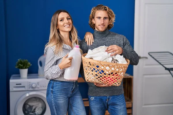 Couple Holding Laundry Basket Detergent Bottle Smiling Happy Cool Smile — Stok fotoğraf