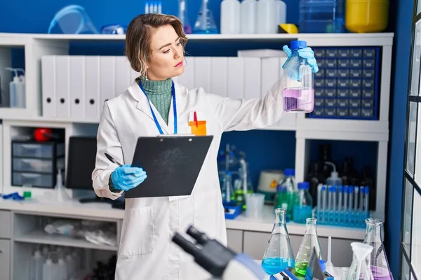 Young Woman Scientist Reading Report Holding Test Tube Laboratory — Stock Photo, Image