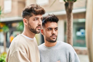 Young couple standing together with relaxed expression at street