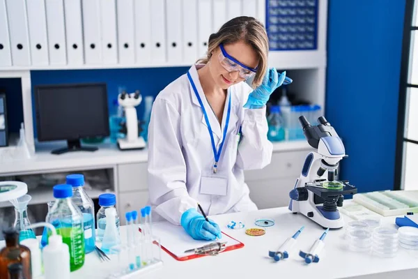 Young Woman Scientist Writing Report Listening Audio Message Laboratory — Stock Photo, Image