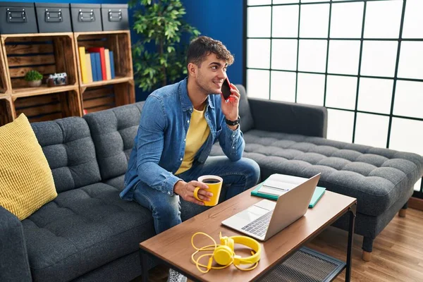 Young Hispanic Man Student Talking Smartphone Drinking Coffee Home — Fotografia de Stock