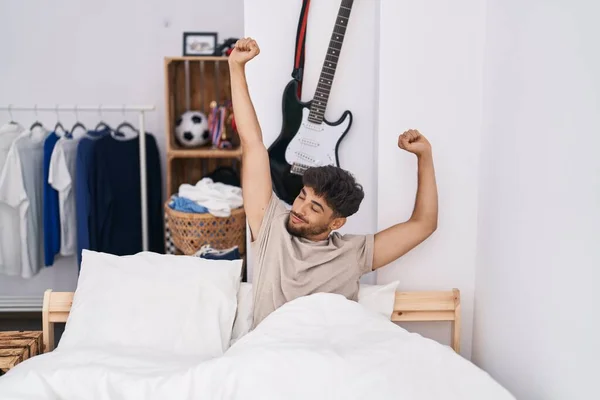 Young Arab Man Waking Stretching Arms Bedroom — Stock fotografie