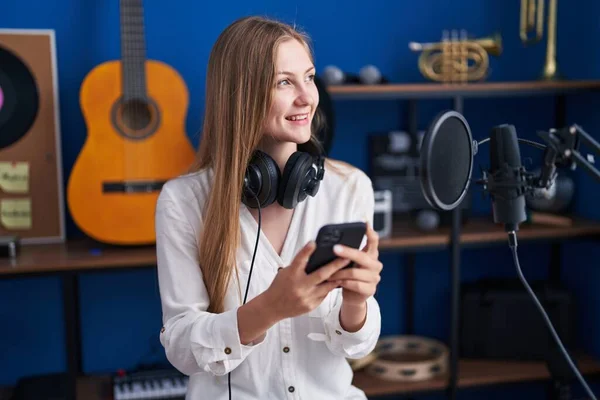 Young Caucasian Woman Artist Smiling Confident Using Smartphone Music Studio — ストック写真