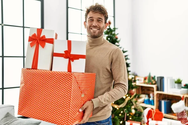 Young Hispanic Man Smiling Confident Holding Christmas Gifts Home — Stock Photo, Image
