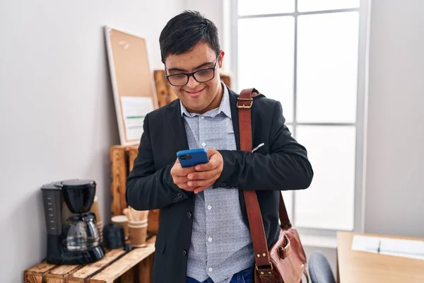 オフィスでスマートフォンを使うダウン症候群の男性ビジネスワーカー — ストック写真
