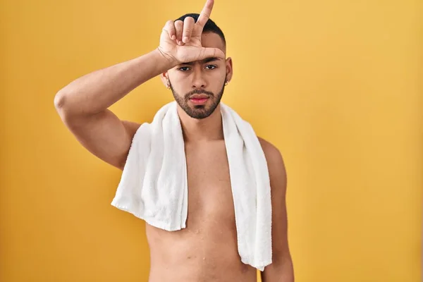 Young Hispanic Man Standing Shirtless Towel Making Fun People Fingers — Stockfoto