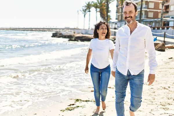 Middle Age Hispanic Couple Smiling Happy Walking Hands Together Beach — Stok fotoğraf