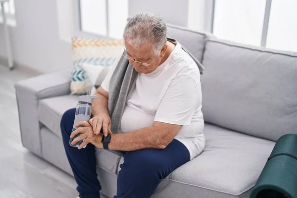 Middle Age Grey Haired Man Looking Watch Sitting Sofa Home — Stock Photo, Image