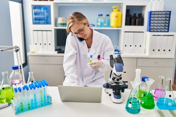 Young Blonde Woman Scientist Talking Smartphone Holding Test Tube Laboratory — Stock Photo, Image
