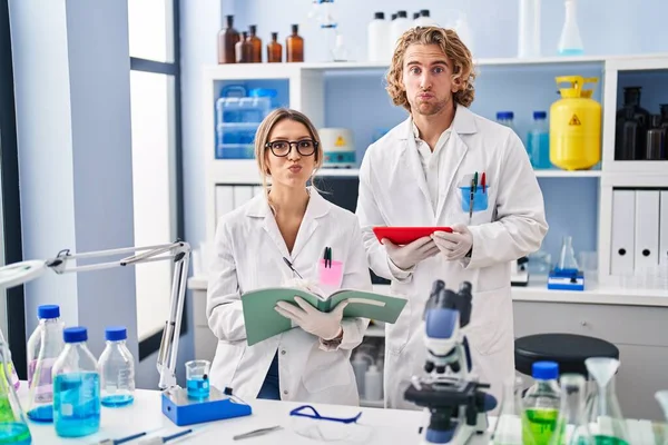 Two People Working Scientist Laboratory Puffing Cheeks Funny Face Mouth — Photo