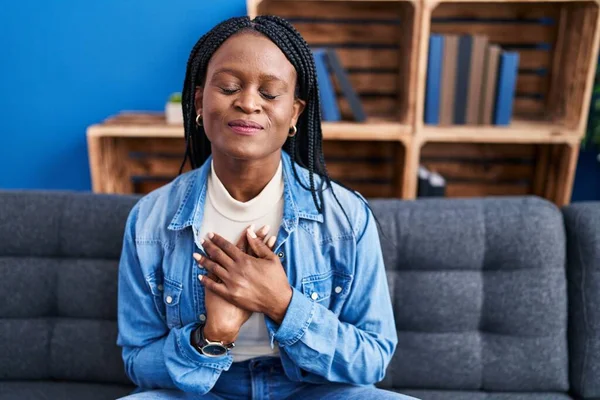 African American Woman Sitting Sofa Hands Heart Home — ストック写真