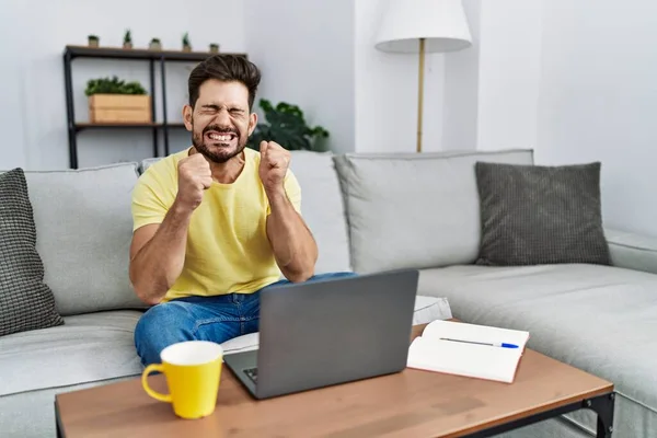 Young Man Beard Using Laptop Home Excited Success Arms Raised — Fotografia de Stock