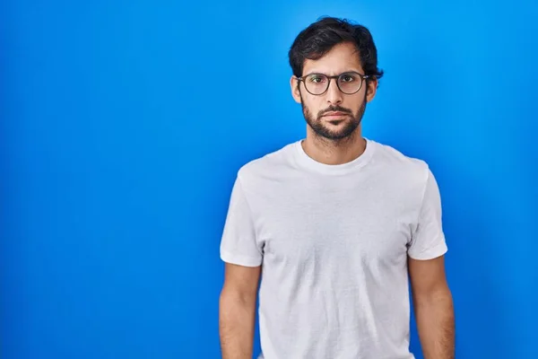 Handsome Latin Man Standing Blue Background Relaxed Serious Expression Face — 图库照片