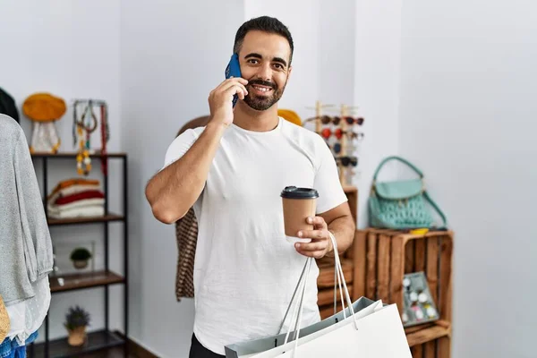 Young Hispanic Man Customer Talking Smartphone Shopping Clothing Store — Fotografia de Stock