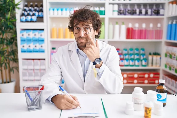 Hispanic Young Man Working Pharmacy Drugstore Pointing Eye Watching You — Stock Photo, Image