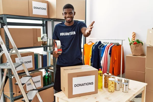 Young African American Volunteer Man Packing Donations Box Charity Smiling — Stockfoto