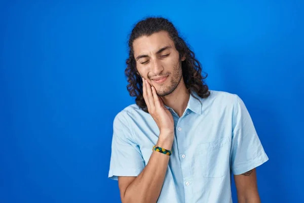 Young Hispanic Man Standing Blue Background Touching Mouth Hand Painful — Zdjęcie stockowe