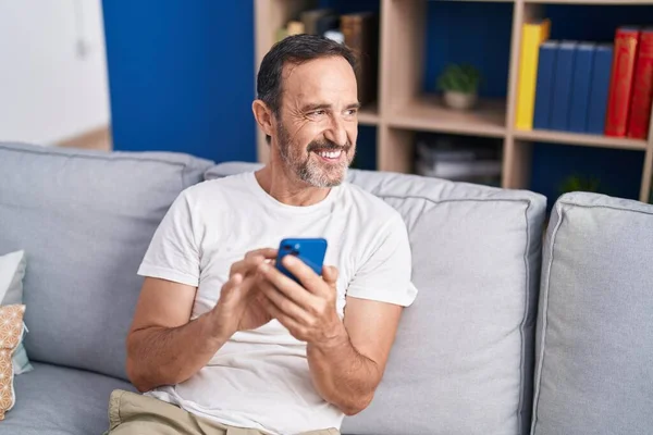 Middle Age Man Using Smartphone Sitting Sofa Home — Stockfoto