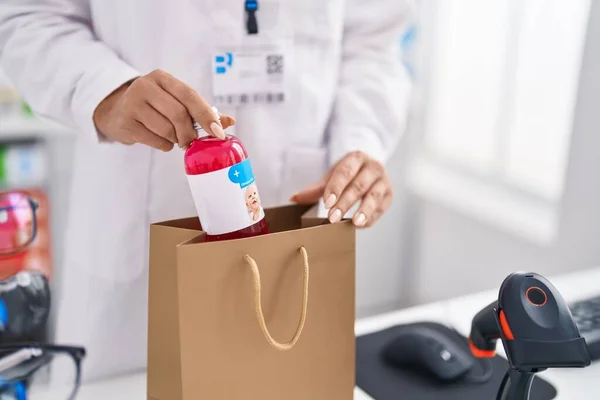 Young Blonde Woman Pharmacist Putting Medication Bottle Shopping Bag Pharmacy — Stockfoto
