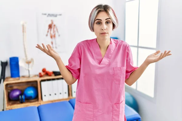 Young Nurse Woman Working Pain Recovery Clinic Clueless Confused Expression — Stock Photo, Image