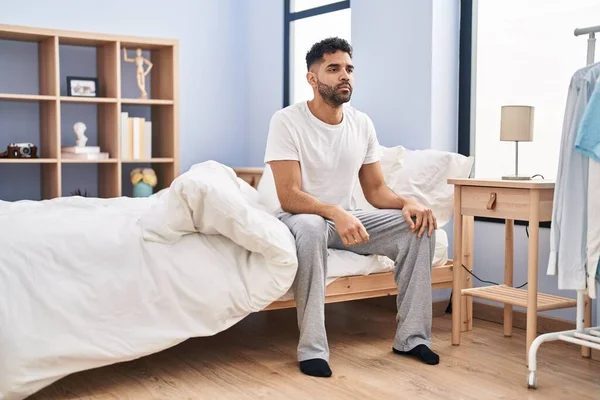 Young Hispanic Man Serious Expression Sitting Bed Bedroom — ストック写真