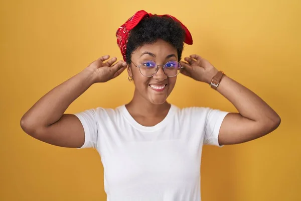Sarı Arka Planda Dikilen Genç Afro Amerikalı Kadın Parmaklarıyla Kulaklarını — Stok fotoğraf