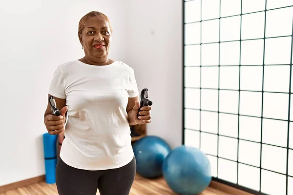 stock image Senior african american woman smiling confident training using grip hand at sport center