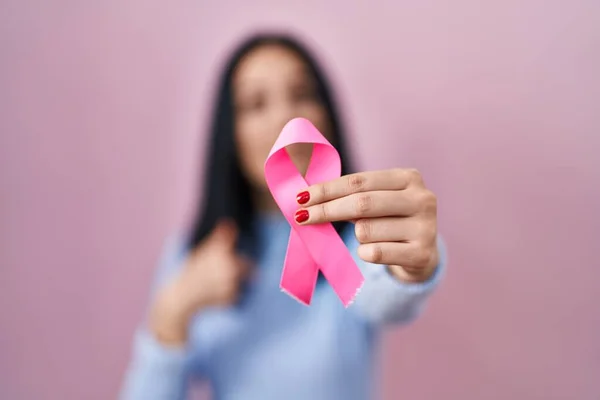 Hispanic Woman Holding Pink Cancer Ribbon Pointing Finger One Self — Stock Photo, Image