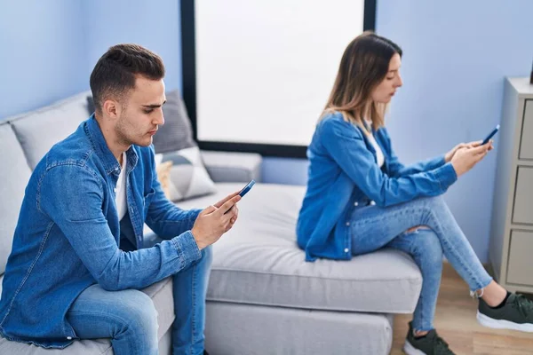 Άνδρας Και Γυναίκα Ζευγάρι Χρησιμοποιώντας Smartphone Κάθεται Στον Καναπέ Στο — Φωτογραφία Αρχείου