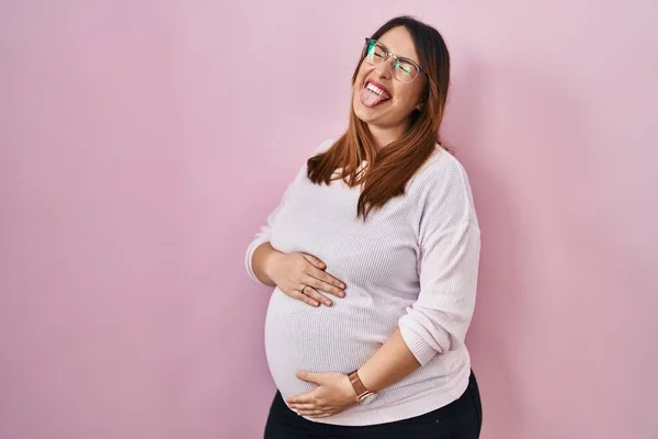 Pregnant Woman Standing Pink Background Sticking Tongue Out Happy Funny — стоковое фото