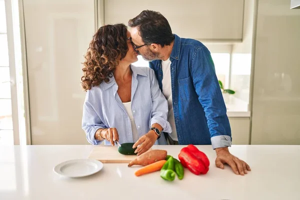 Middle Age Hispanic Couple Kissing Hugging Each Other Cooking Kitchen —  Fotos de Stock
